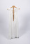 Back view of christening gown hung from wooden hanger with back tie visible