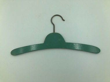 Green colored wooden hanger, child size, laid flat.