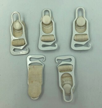 Five identical suspenders. Four are viewed from their front and one from its back.