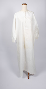 Front view of cream-colored nightdress - long with long sleeves.