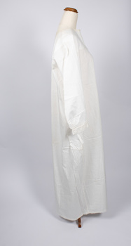 Side view of cream-colored nightdress with one long sleeve visible.
