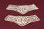 Two matching lace cuffs.