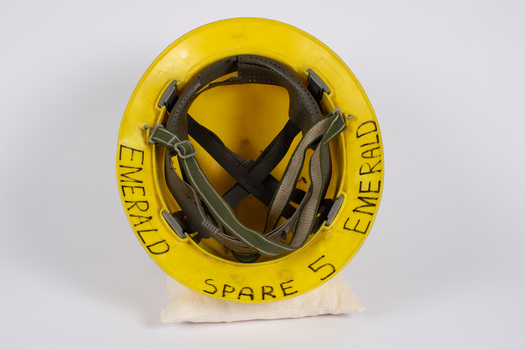 Underneath view of fire fighter's helmet showing adjustable head harness and labelling