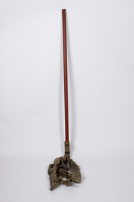 Front view of fire fighters beater showing long wooden pole with heavy duty textile straps attached.