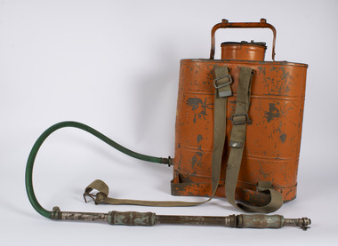 Back of Fire Fighting Knapsack showing orange tank with two straps attached and hose and pump handle.