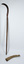 Scythe with blade upright and blade cover on the ground beside the handle