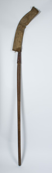 Scythe upright with protective cover over blade