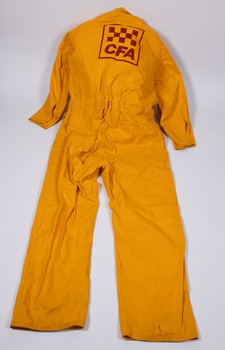 Back view of yellow-colored fire fighter overalls laid flat with CFA logo visible