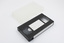 VHS tape and clear plastic container.