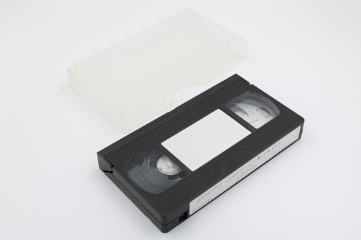 VHS tape and clear plastic container.