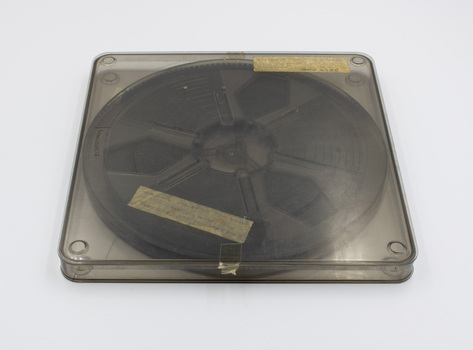 View of top of clear plastic film case showing label and film inside.