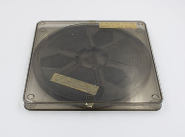View of top of clear plastic film case showing label and film inside.