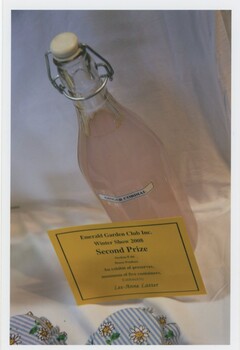 Bottle of ginger cordial with a stopper with 'Second Prize' card in front.