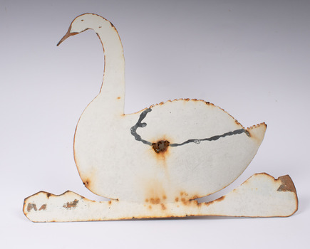 Front view of metal swan showing attachment hole in the centre.