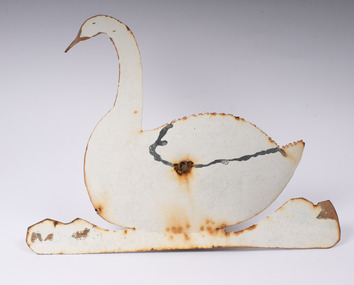 Front view of metal swan showing attachment hole in the centre.