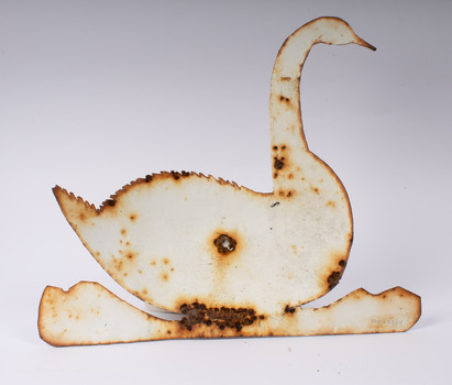 Back view of metal swan showing attachment hole in the centre and some rust around the edge and at the hole.