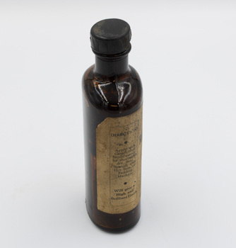 Left side of finishing ink bottle, featuring directions for use.