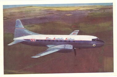 Side view of TAA airline in flight over a predominantly brown landscape