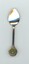 Silver-plated commemorative teaspoon with round metal plaque on handle