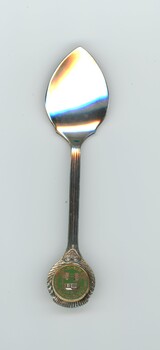 Silver-plated commemorative teaspoon with round metal plaque on handle