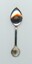 Back of silver-plated commemorative teaspoon with decorative markings on handle