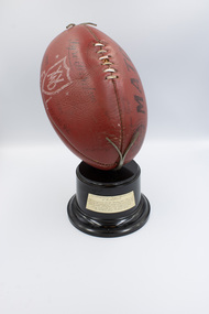Front view of football trophy with inscription visible