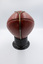 Back view of football showing a metal clasp securing it to the stand