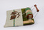 Side view of lace maker with wooden bobbins, wooden handle and wooden barrel visible