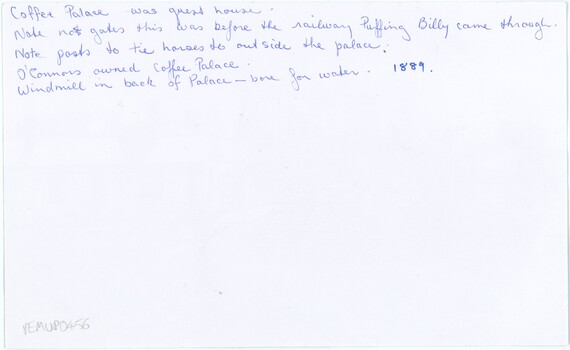 Reverse of a printed photograph, with handwritten annotation in blue pen (with a year written in a different pen), and an accession number in pencil.