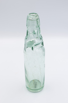 Empty glass bottle with Codd Neck design and a glass marble visible in the neck.