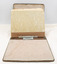 Manual open to reveal rear of patterned inner cover, with patterned outer cover rear visible.  