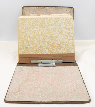 Manual open to reveal rear of patterned inner cover, with patterned outer cover rear visible.  