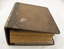 A closed manual, looking down at an angle to capture the cover and the bottom edges of pages.