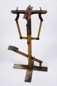 Nursery hole punch, looking from the far side of the lever, perpendicular to it.