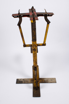 Nursery hole punch, looking from the far side of the lever, parallel to it.