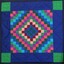 Front of patchwork quilt - design is mainly in blue and green colors with some pink and burgundy.