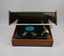 Front of turntable opened to show record and tonearm holding cartridge and stylus.