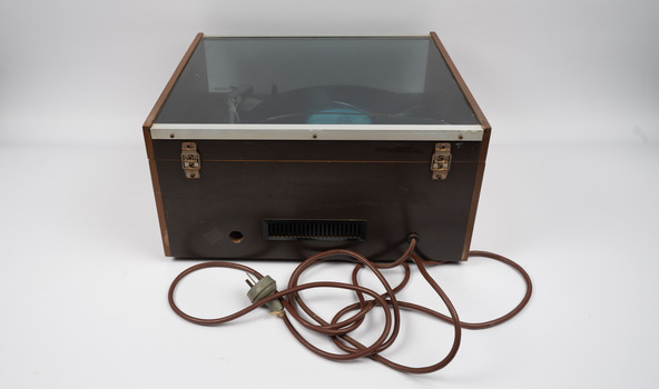 Back of turntable with electrical cords.