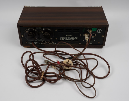 Back of amplifier with a mass of electrical cords in foreground.