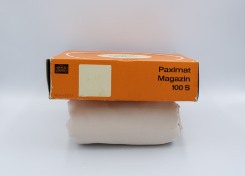 Side view of orange box of rotary slide magazine with German name visible.