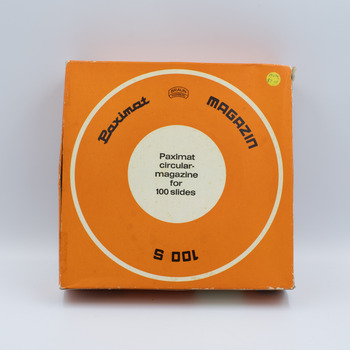 Top view of orange box containing rotary slide magazine with information in English in the centre of box and small price sticker in top right.