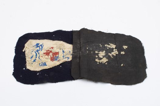 Back of hospital badge laid out showing some wear