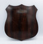 The wooden reverse of a shiled-shaped trophy plaque.