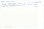 The paper reverse of a photograph, with writing in blue pen.