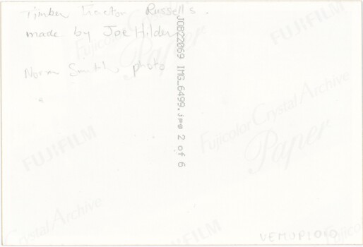 The reverse of a printed photograph, featuring some handwritten text and printed technical details of the photograph.