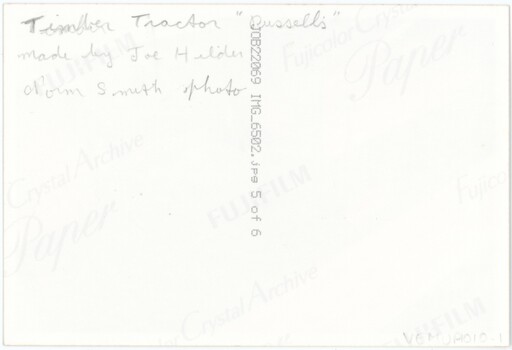 The reverse of a printed photograph, featuring some handwritten text and printed technical details of the photograph.
