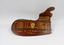 Front of rudder showing individual names of the winning rowing team inscribed in gold lettering.