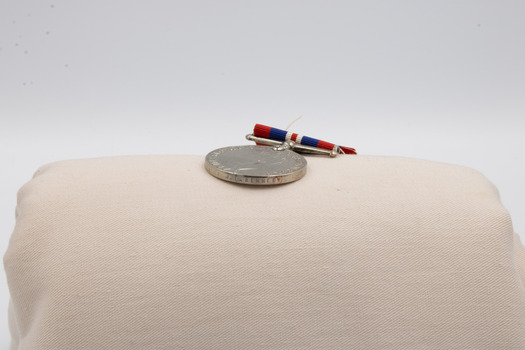 The edge of a, the 1939 to 1945 medal, revealing text.