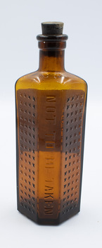 Back of poison bottle with stopper - upright.