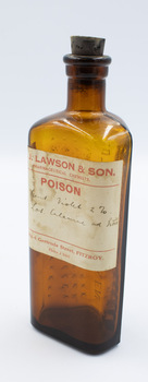 Front of poison bottle with stopper upright viewed from off-centre